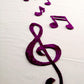 Artistic placement of music key and music note applique pieces