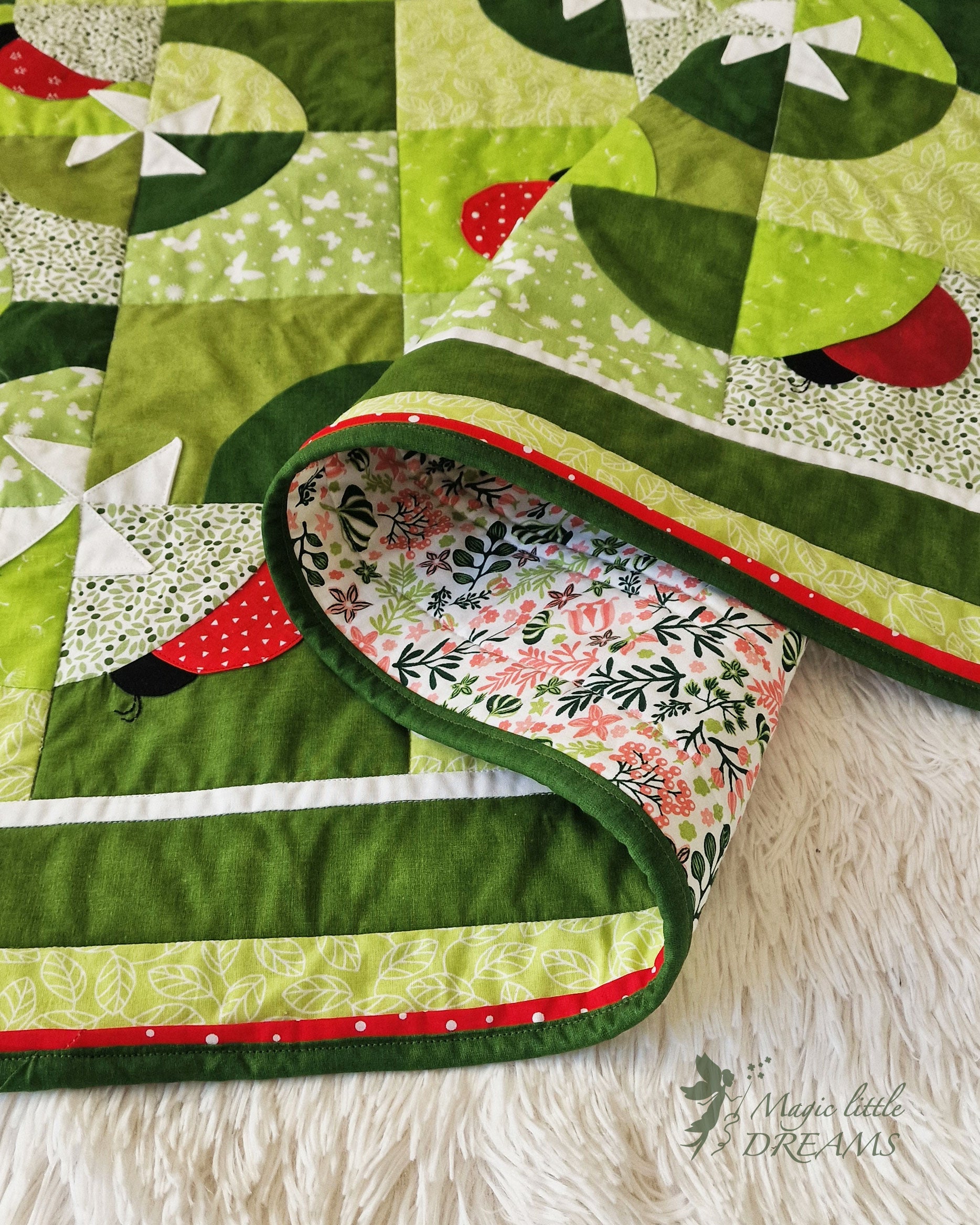 Close-up of the Ladybug Wonderland quilt’s stunning red flange binding, showcasing the clean, professional stitching that adds a beautiful finishing touch to the quilt.