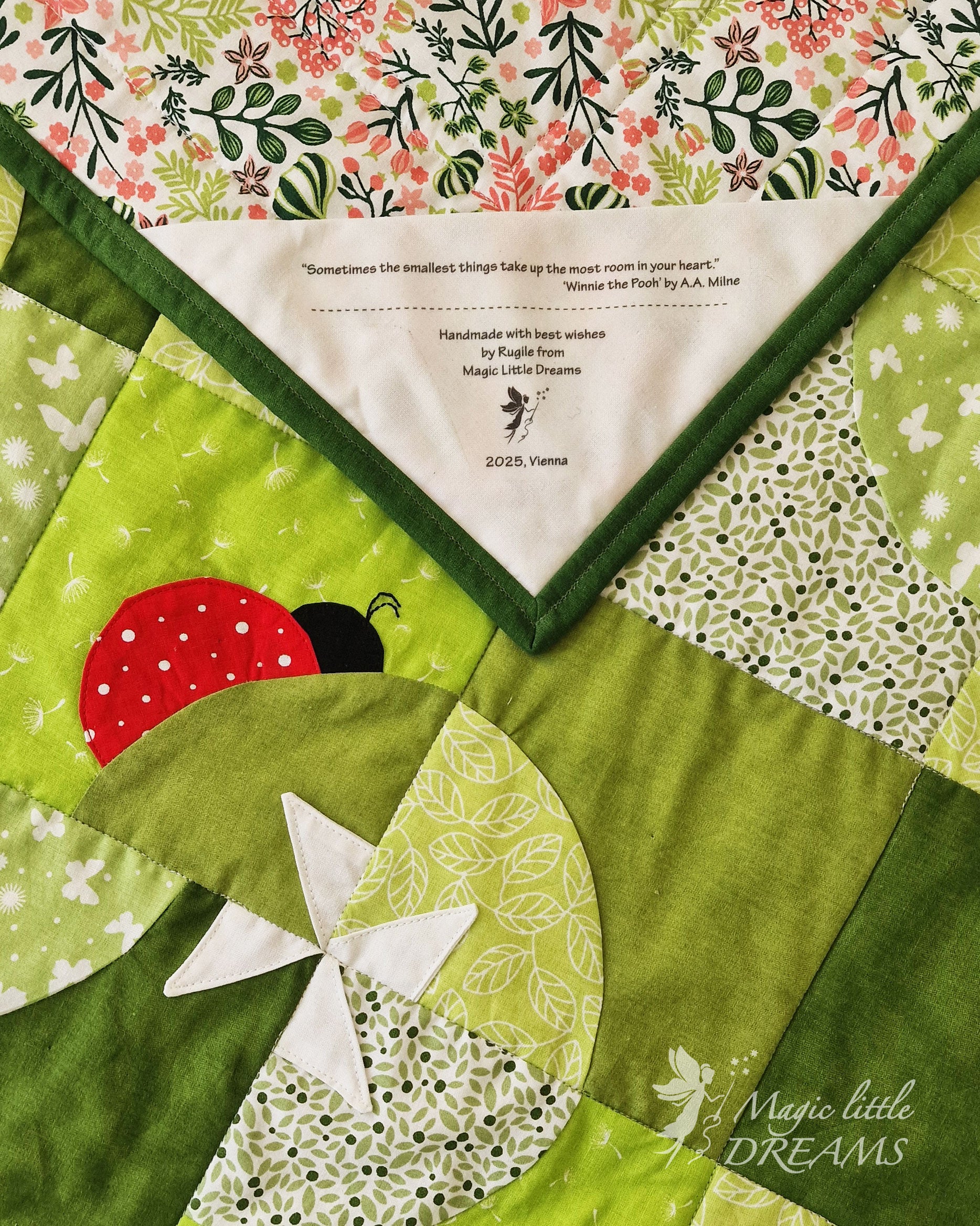 Close-up of the Ladybug Wonderland quilt, featuring a red ladybug, a pinwheel flower, and the quilt label, showcasing the playful design and the quilts personalized touch.