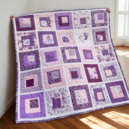 Purple and white baby quilt on a wooden floor with sunlight streaming through a window.
