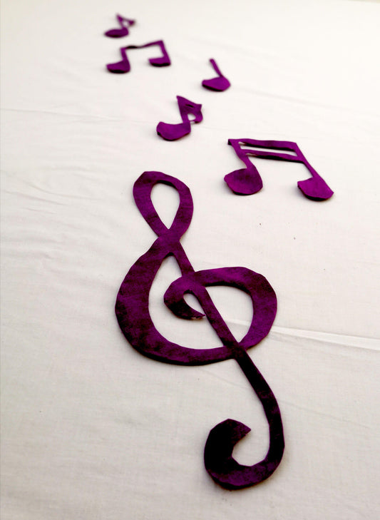 Artistic placement of music key and music note applique pieces