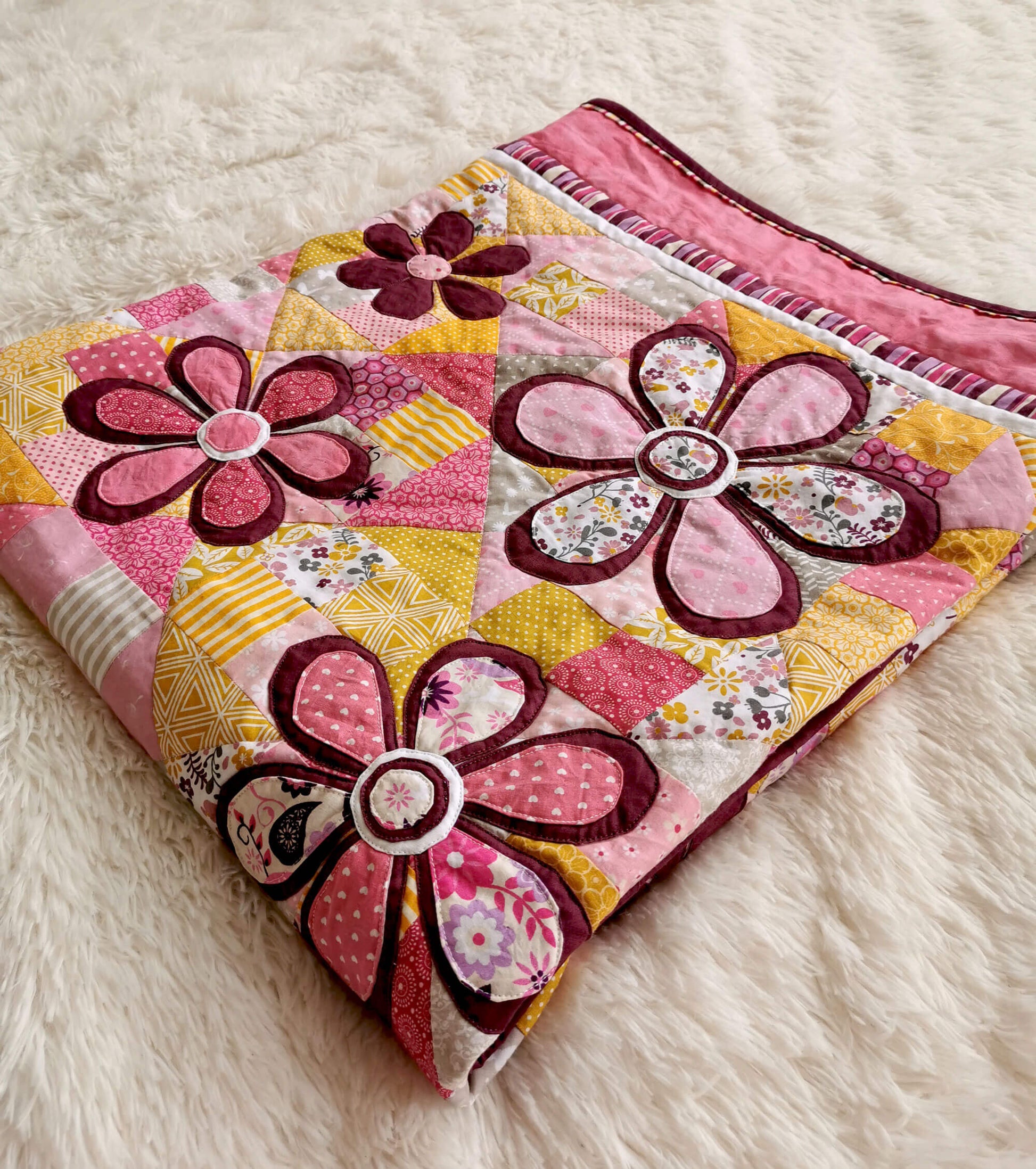 Pink yellow quilt with flowers for a girl