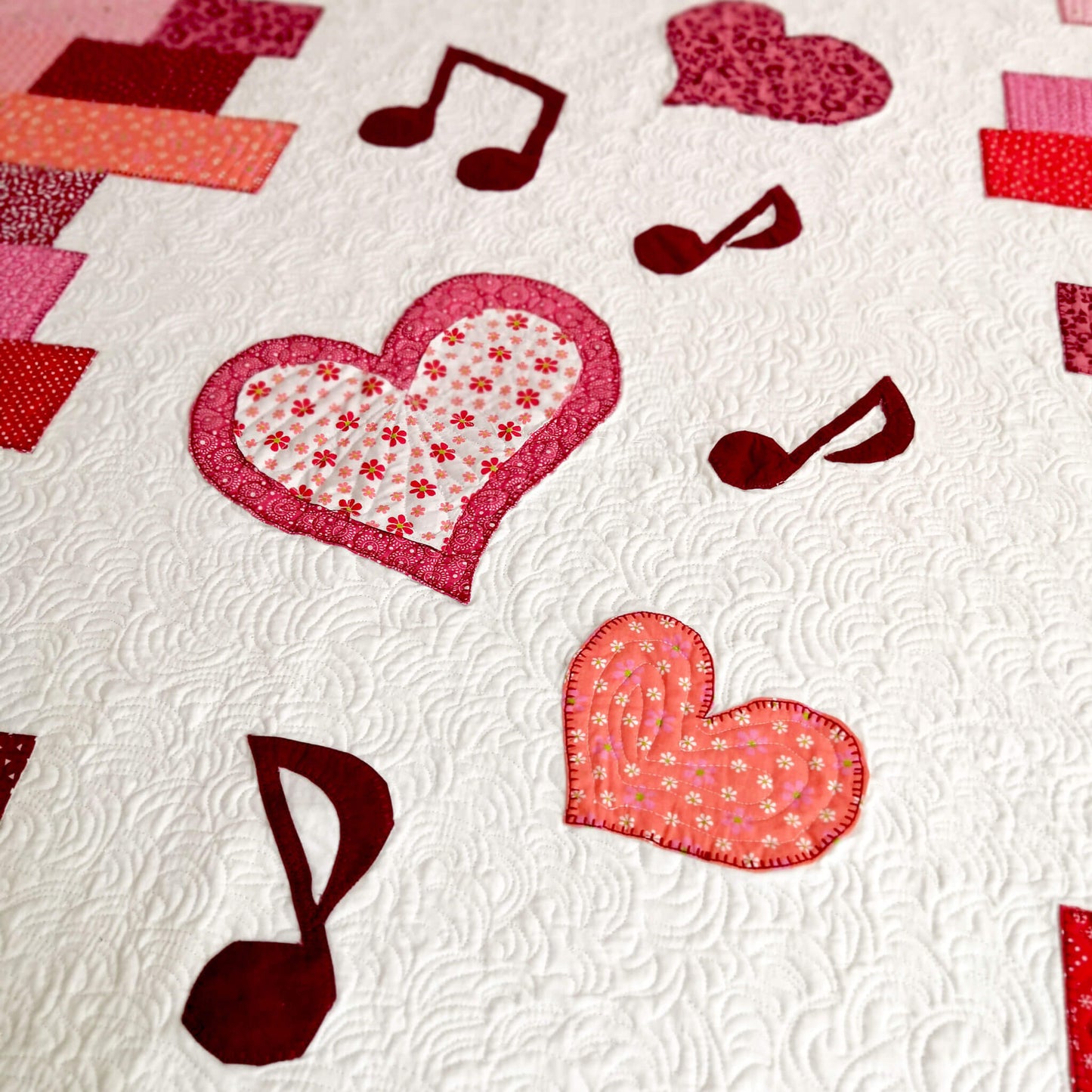 Fragment of "Music of Love" quilt with heart and music note appliques